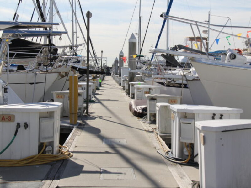 pathway and yacht parked on both side of the dock