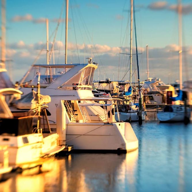 The white color luxury boat in the marina at sunset